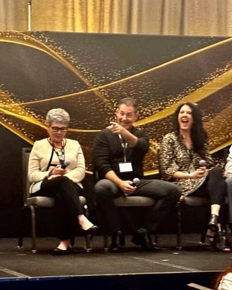 Rob Lancit on a Franchise Assembly panel, microphone in hand, pointing toward the audience