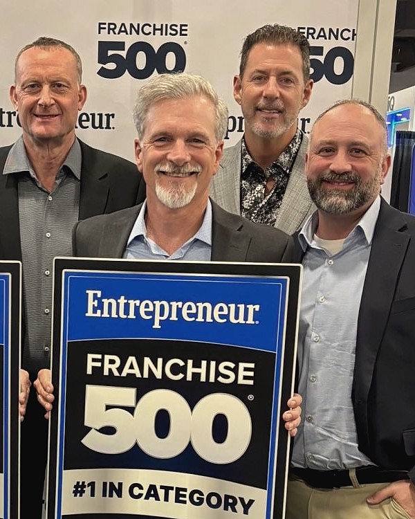 Rob Lancit with the Stratus team at the Entrepreneur Franchise 500, 2025, holding the #1 in Category sign